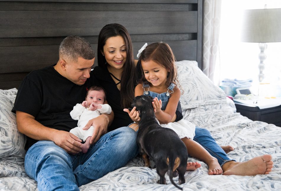 Example of a family photography session that includes their dog alongside their newborn.