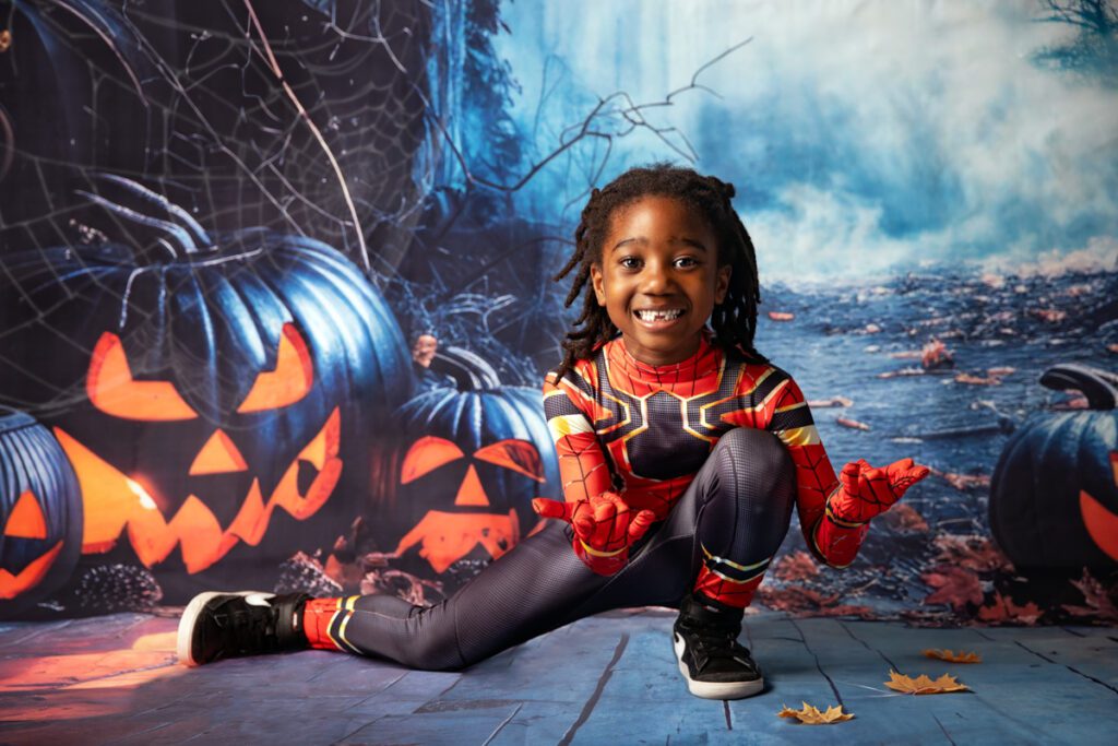 Boy in Spider-Man costume at school Halloween photoshoot